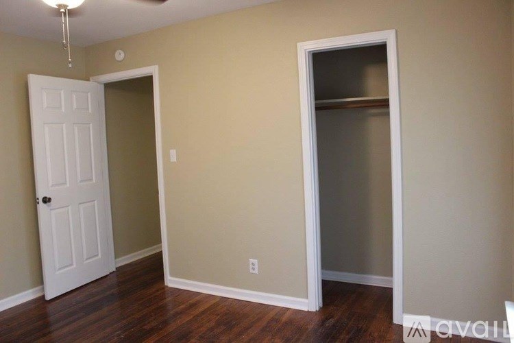 A room with a white door and a window.