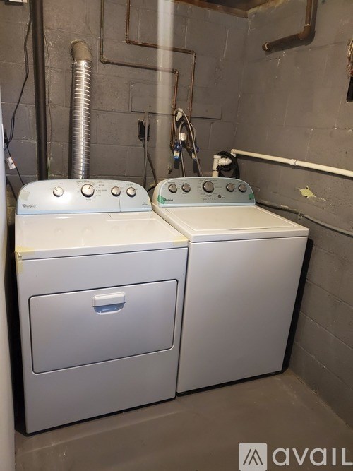 Two washing machines in a laundry room.