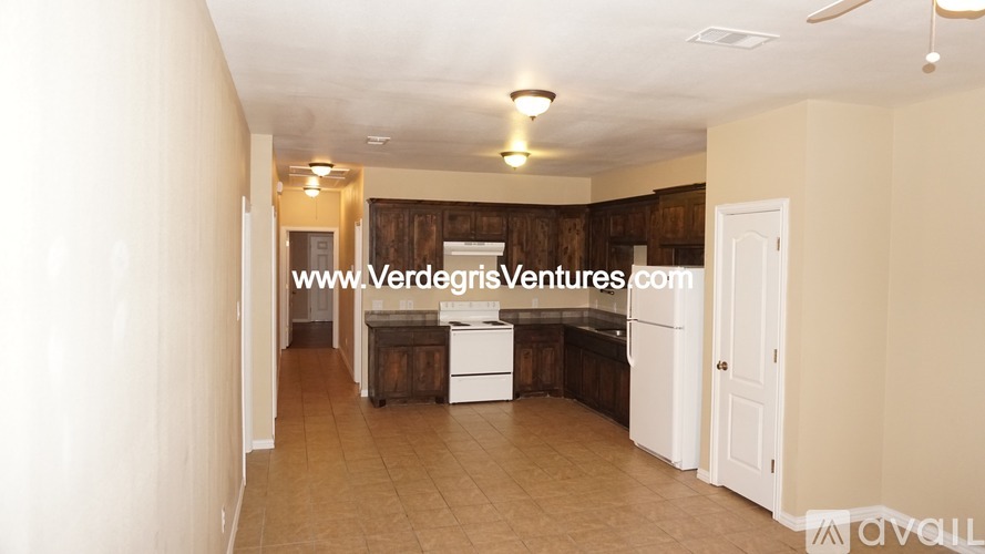 A room with a white door and a wooden cabinet.