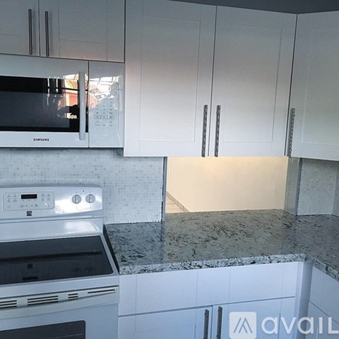 A kitchen with a white oven and microwave.