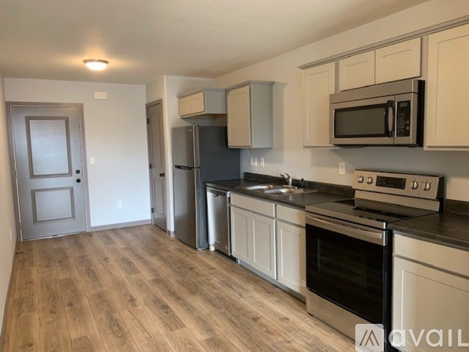 A kitchen with a black stove top oven and a black microwave above it.