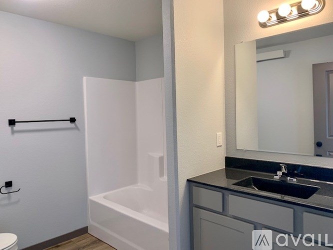 A bathroom with a white tub and sink.