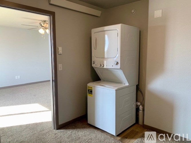 A white oven and microwave are installed in a room.