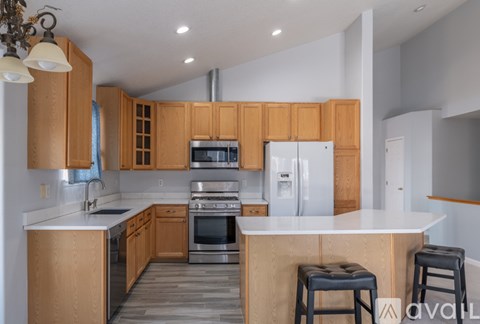 A kitchen with wooden cabinets and stainless steel appliances.