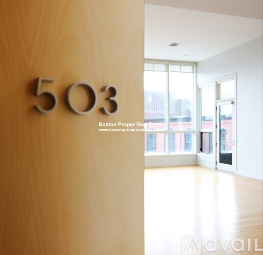 A room with a wooden door that says 503 on it.