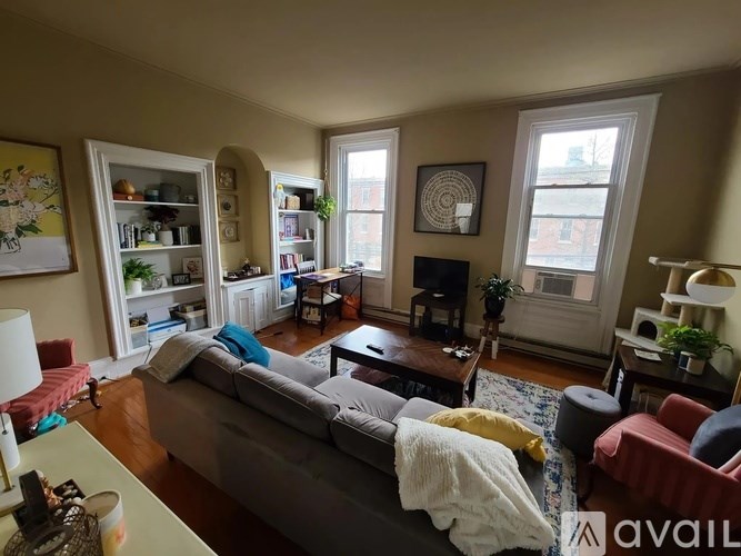 A living room with a grey couch and a coffee table.