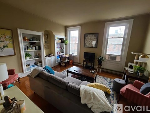 A living room with a grey couch and a coffee table.