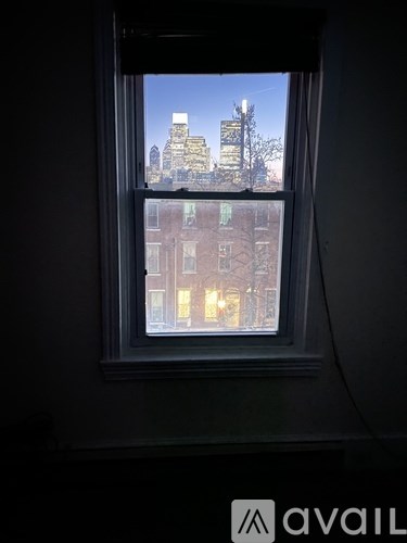 A window with a view of a cityscape outside.