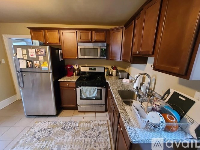 A kitchen with wooden cabinets and a refrigerator.