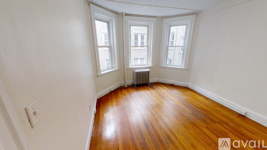 A room with wooden floors and white walls.