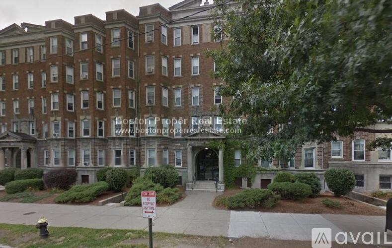 A building with a sign that says "Boston Provider Real Estate" in front of it.