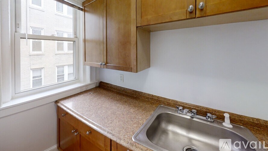 A kitchen with wooden cabinets and a granite countertop.