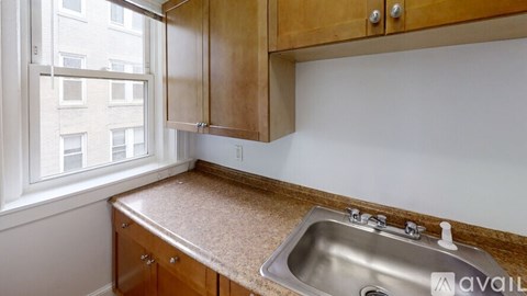A kitchen with wooden cabinets and a granite countertop.