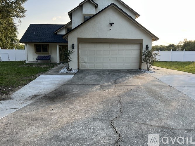 A house with a garage and a driveway in front.
