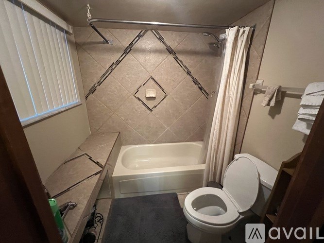 A bathroom with a toilet, sink, and bathtub.