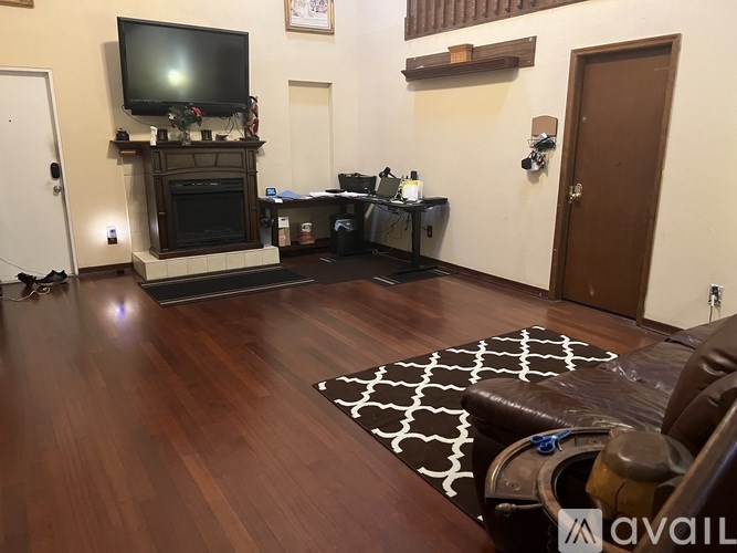 A living room with a fireplace and a television on top of it.