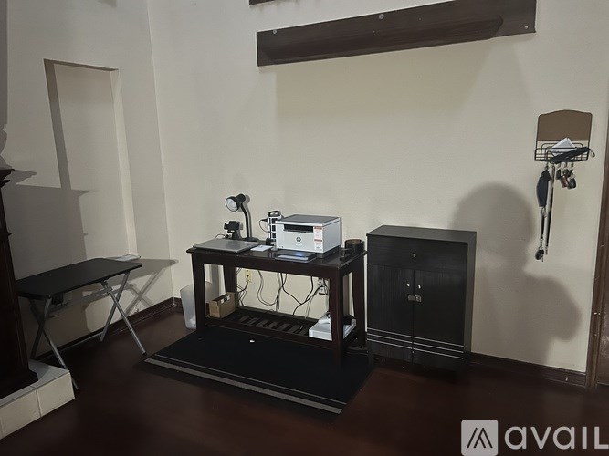 A black table with a laptop and a projector on it.