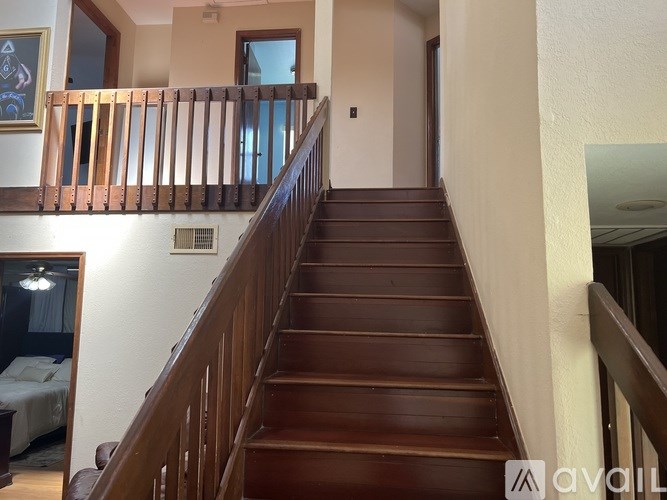A staircase with wooden steps and handrails.