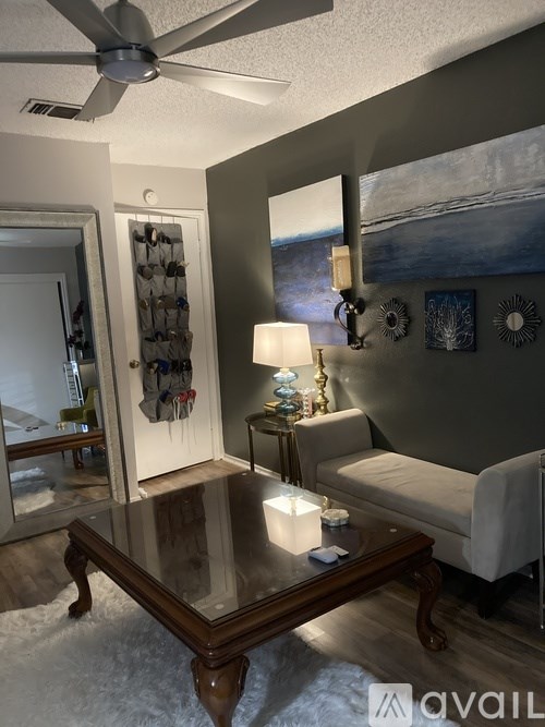 A living room with a wooden coffee table and a white couch.