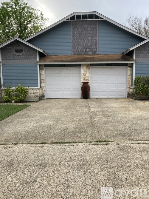 A two-car garage is attached to a house.