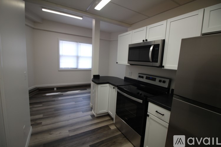 A kitchen with black countertops and white cabinets.