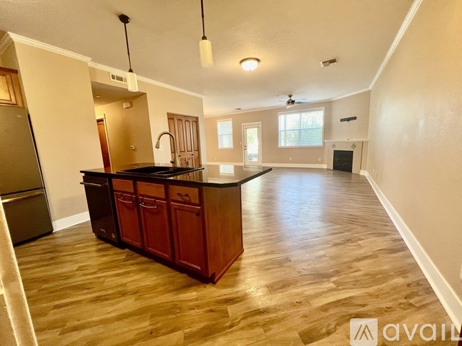 A kitchen with wooden cabinets and a black countertop.