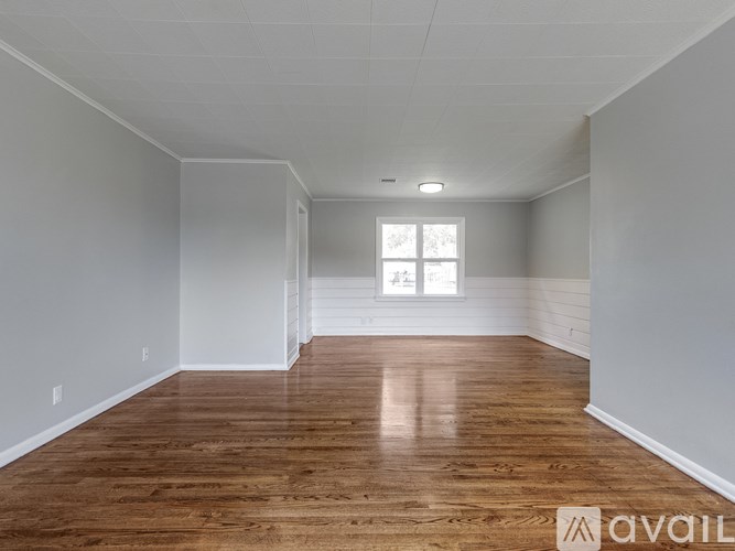 A room with wooden floors and white walls.