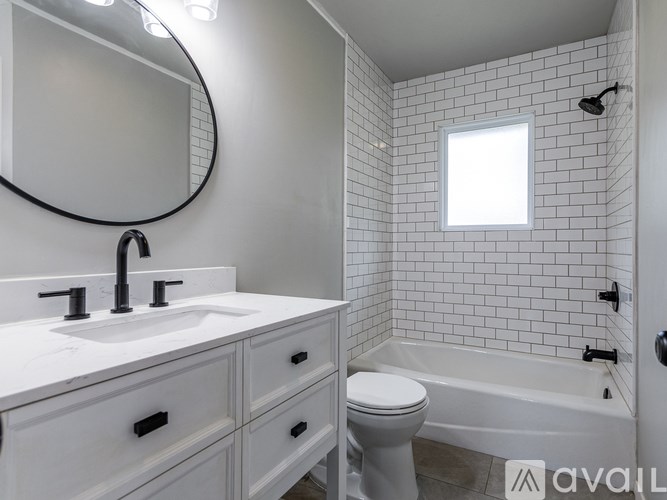 A bathroom with a white sink, toilet, and bathtub.