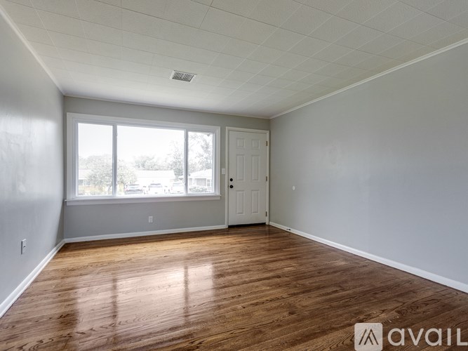 A room with wooden floors and a white door.