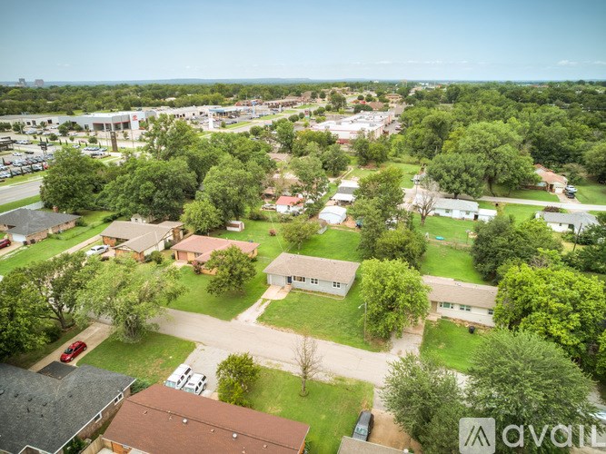 A bird's eye view of a residential area with houses and trees.