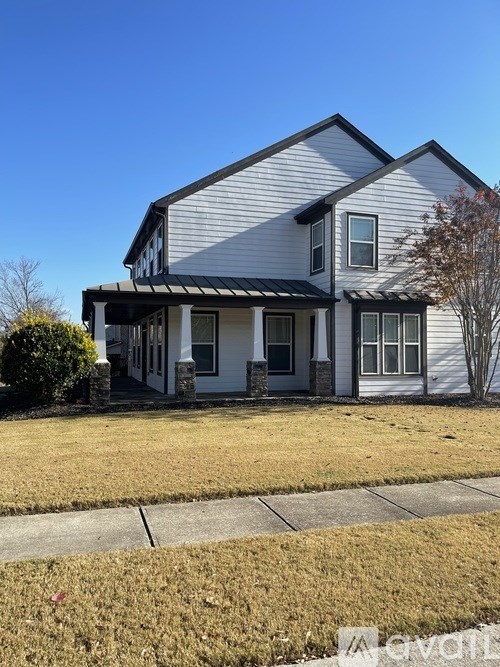 A two-story house with a grey and white exterior.