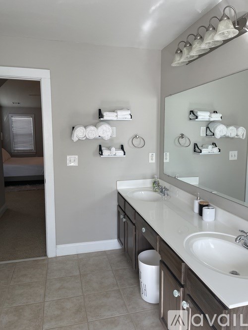 A bathroom with a white sink and a mirror.