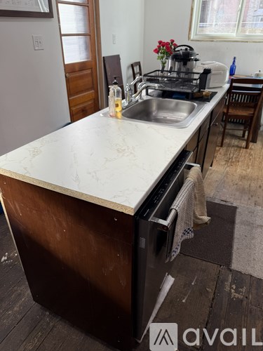 A kitchen with a sink and a dishwasher.