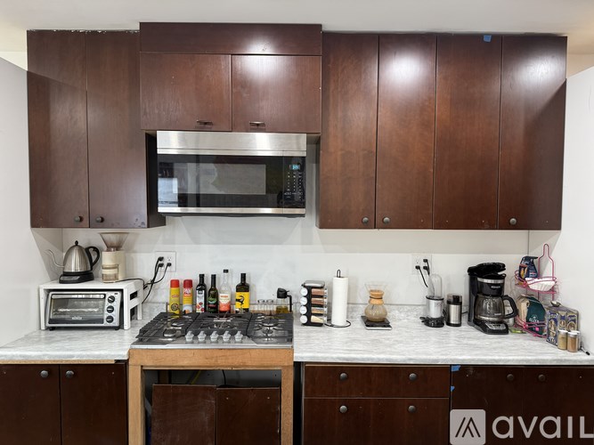 A kitchen with brown cabinets and a white countertop.
