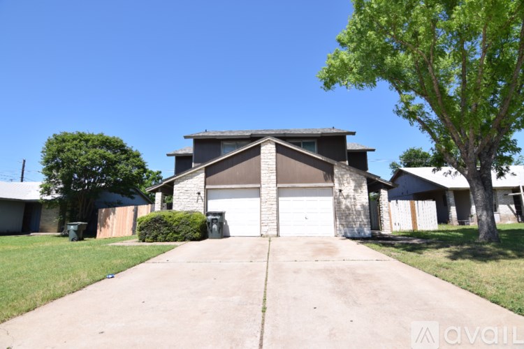 A house with a driveway in front of it.