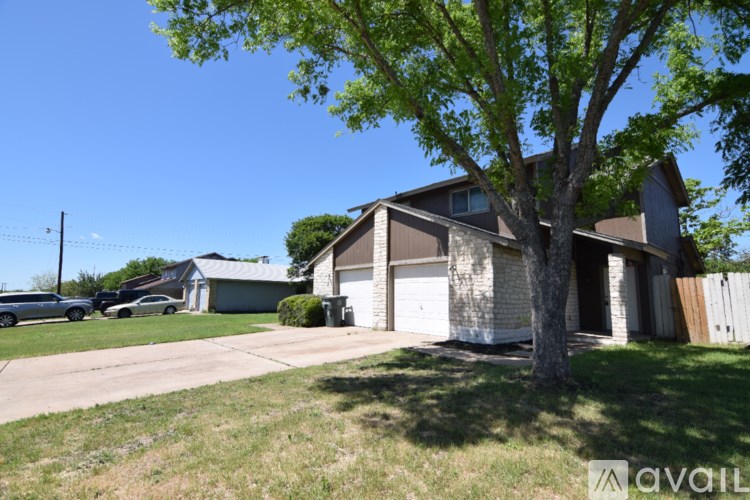 A house with a tree in front of it.