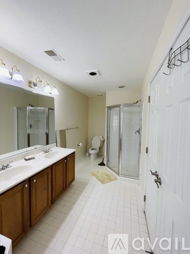 A bathroom with a white sink and a white door.