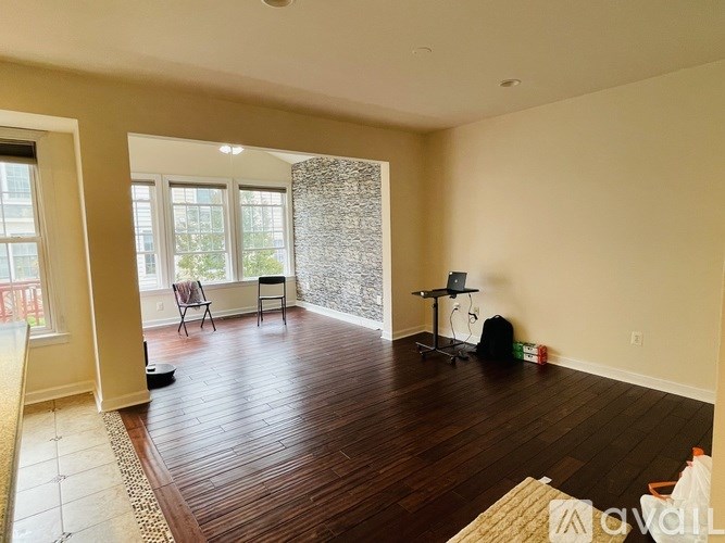 A room with wooden floors and a large window.