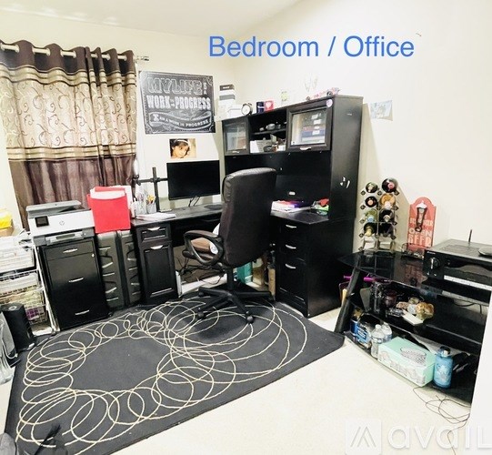 A room with a desk and a computer.