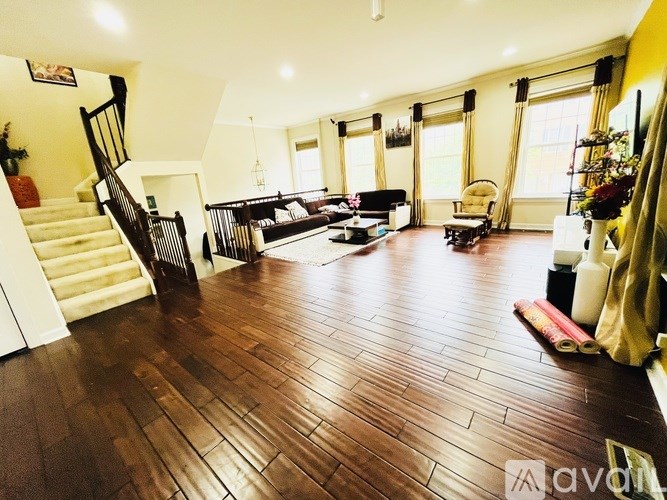 A living room with a staircase and a couch.