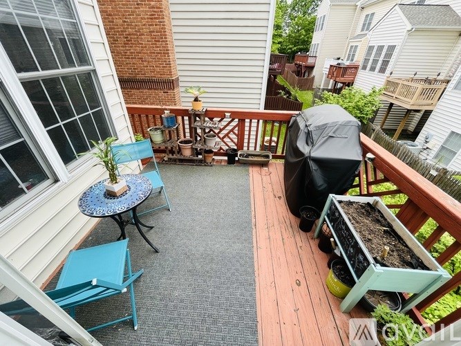 A small balcony with a table and chairs.