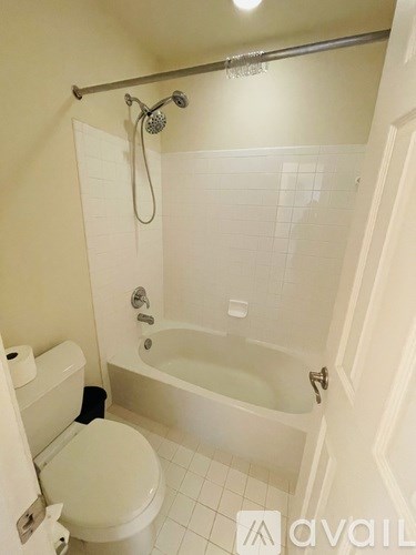 A white toilet is next to a white bathtub in a bathroom.