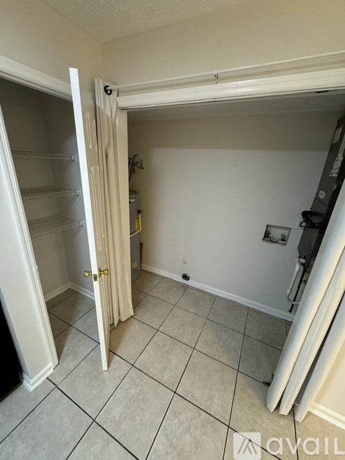 A kitchen with a white fridge and a white door open.