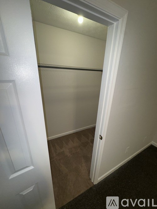 A white door is open to a hallway.