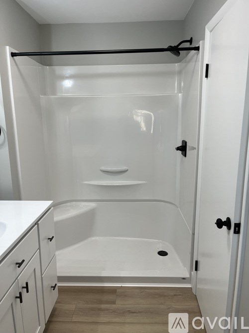 A white bathroom with a walk in shower and a bathtub.