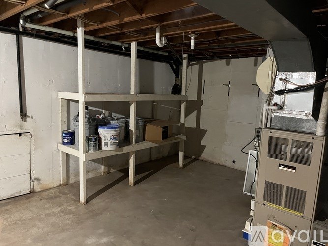 A room with a wooden beam ceiling and a furnace on the right side.