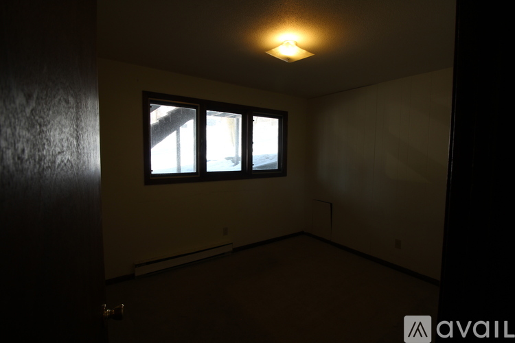 A room with a window and a door.