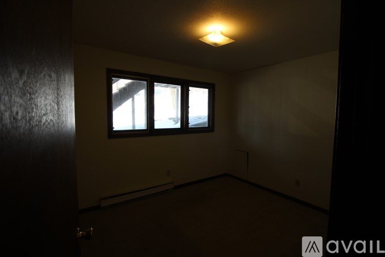 A room with a window and a door.