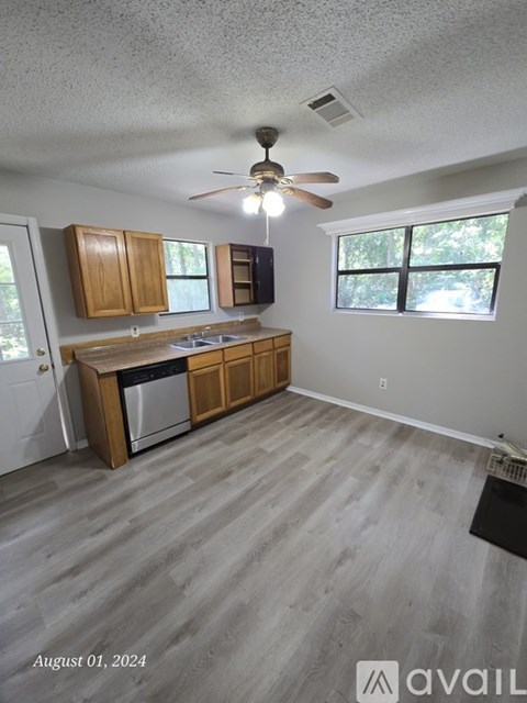 A kitchen with wooden cabinets and a stainless steel oven.