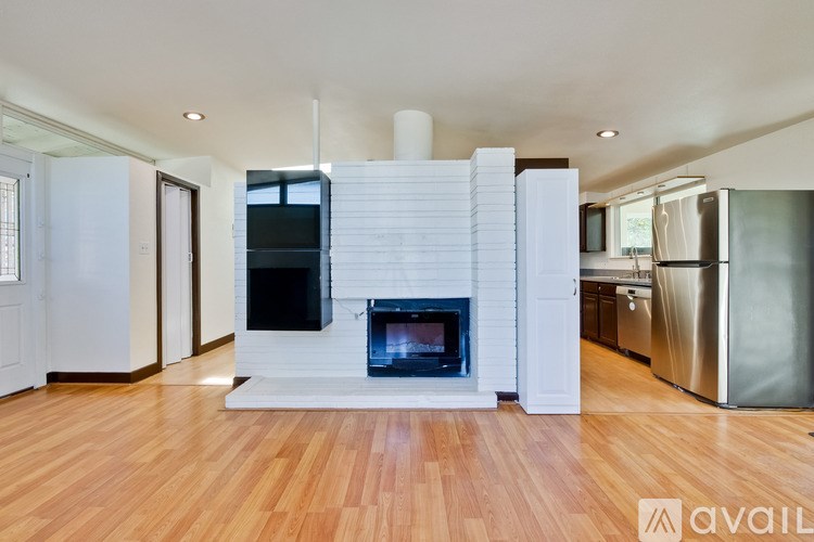 A modern living room with a fireplace and wooden floors.